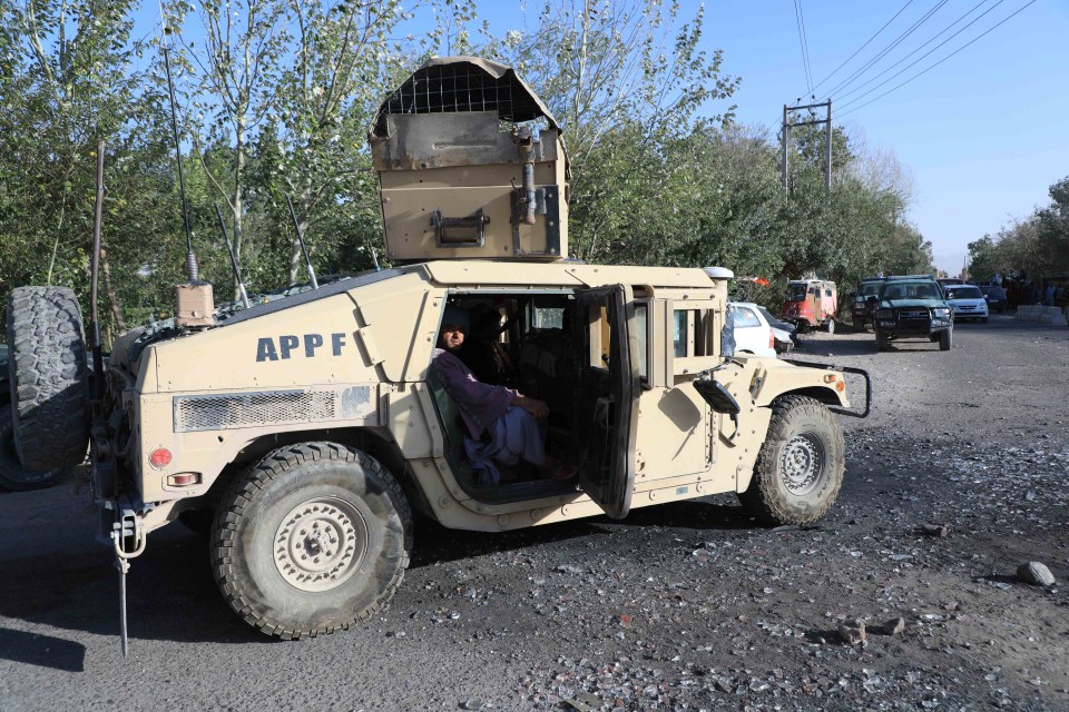 Taliban use a captured Afghan security forces vehicle