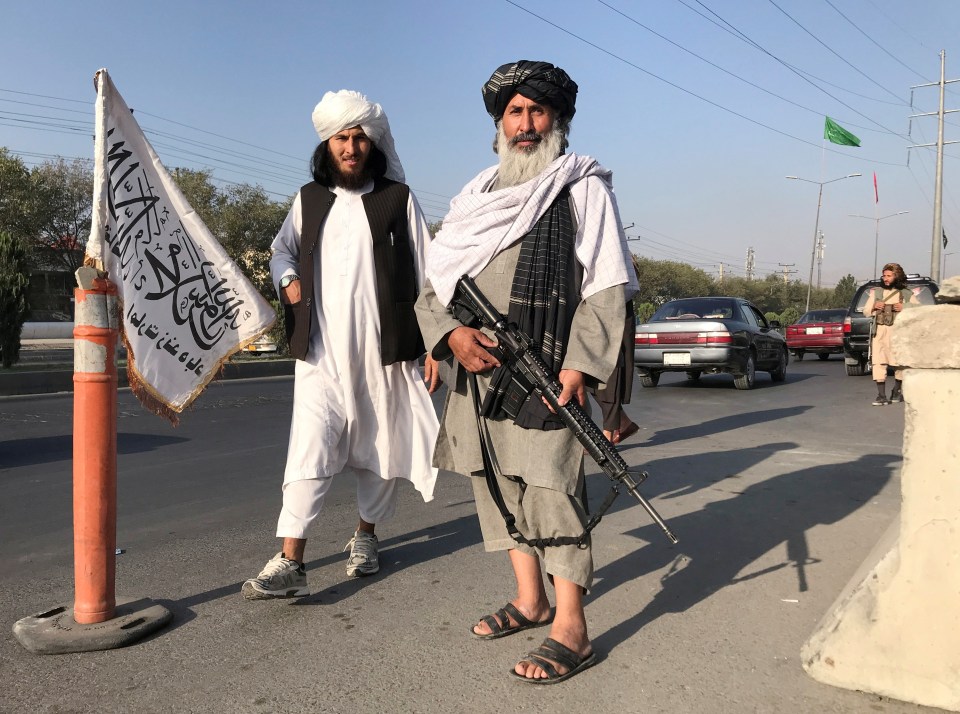 Taliban fighters stand outside the Interior Ministry in Kabul