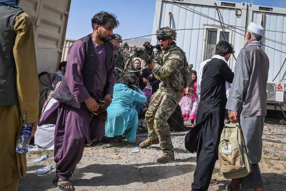 A US soldier points his gun as they protect Kabul airport