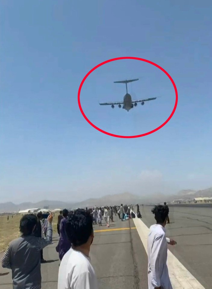 Footage shows the plane taking off with some people clinging to the side