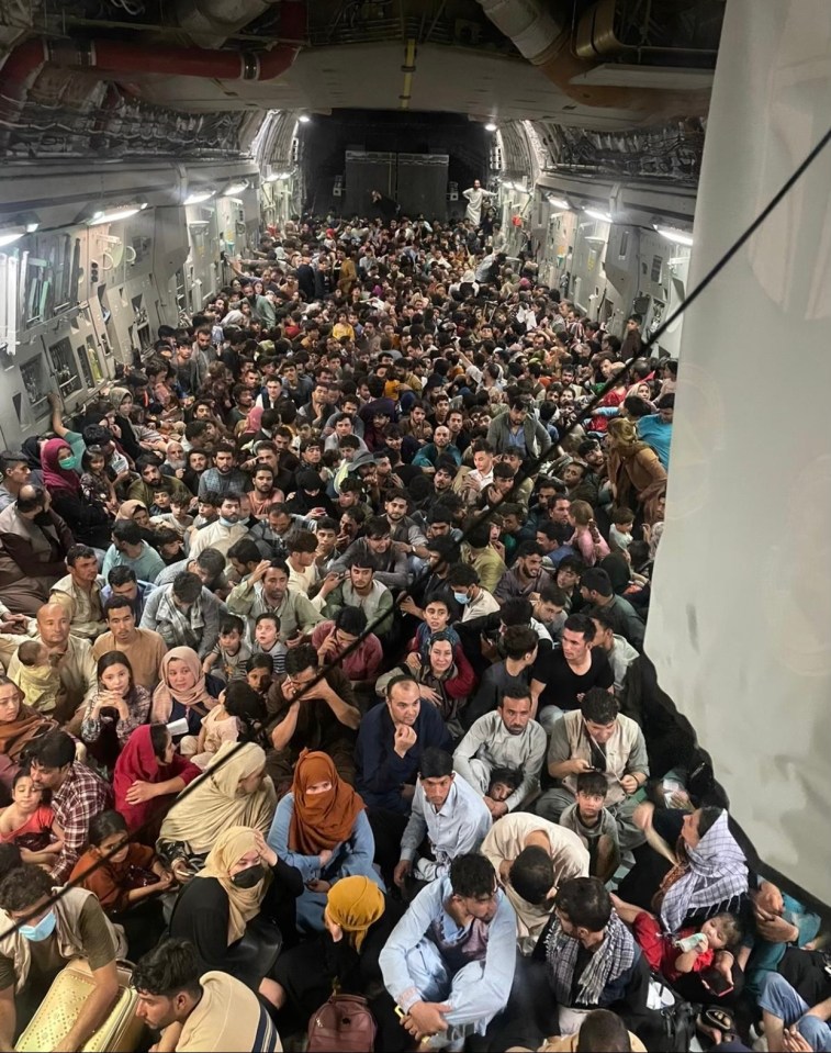 Around 640 terrified refugees cram into the cargo bay of a C-17 jet to escape Kabul