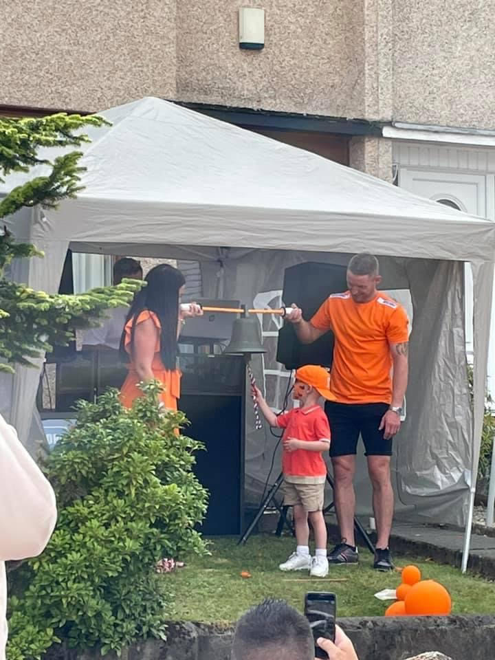 Robbie ringing the bell to signal the end of his treatment in August