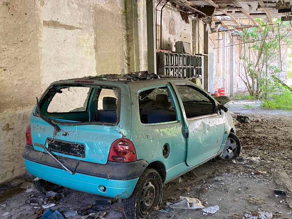 Curiously, the car in the factory was riddled with bullet marks. Lots of them