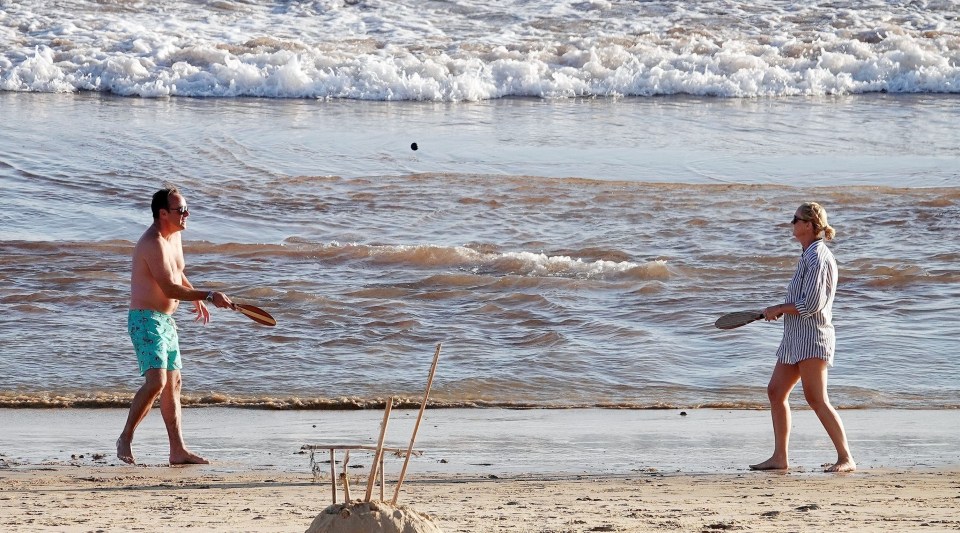 The couple were seen playing bat and ball in the sand