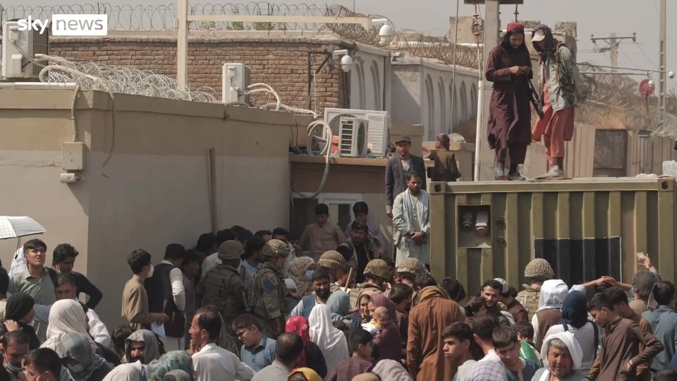 Taliban fighters on containers at Kabul airport