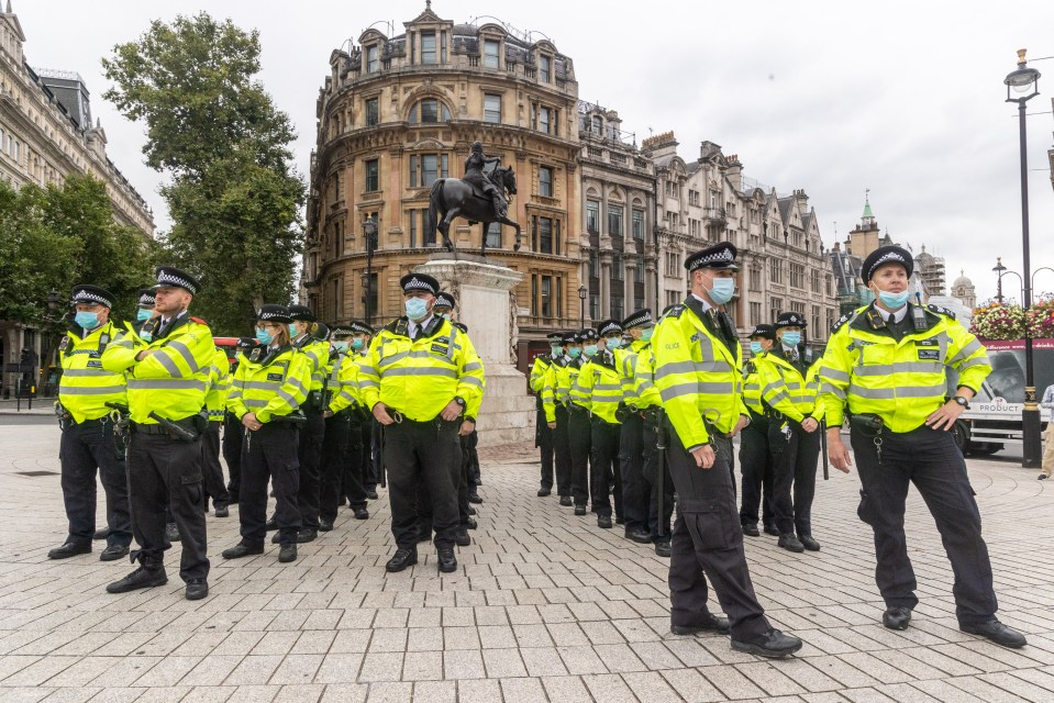 Officers are seen gathered around statues of historic figures