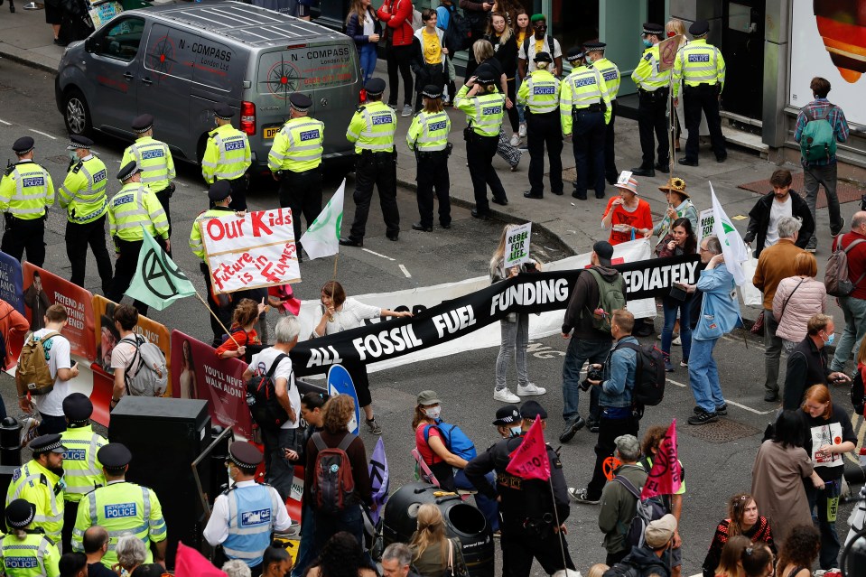 Police are seen standing along a road to block it off from demonstrators