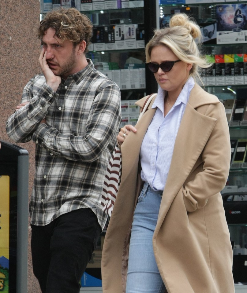 Emily opted for a blue and white shirt, jeans and a smart coat, while Seann opted for a checkered shirt