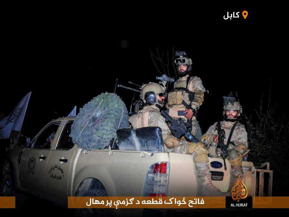 Taliban fighters in the back of a Ford pickup truck