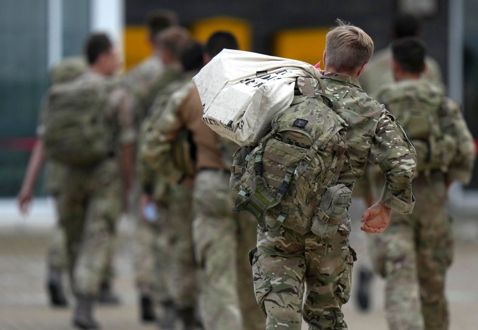 Soldiers were seen carrying their belongings along the tarmac in August