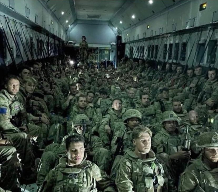 Western soldiers crammed into a plane on their way home from Afghanistan three years ago