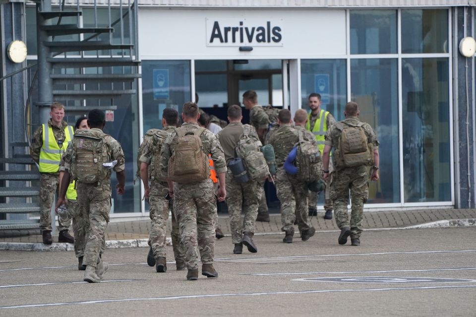 The troops are escorted through RAF Brize Norton