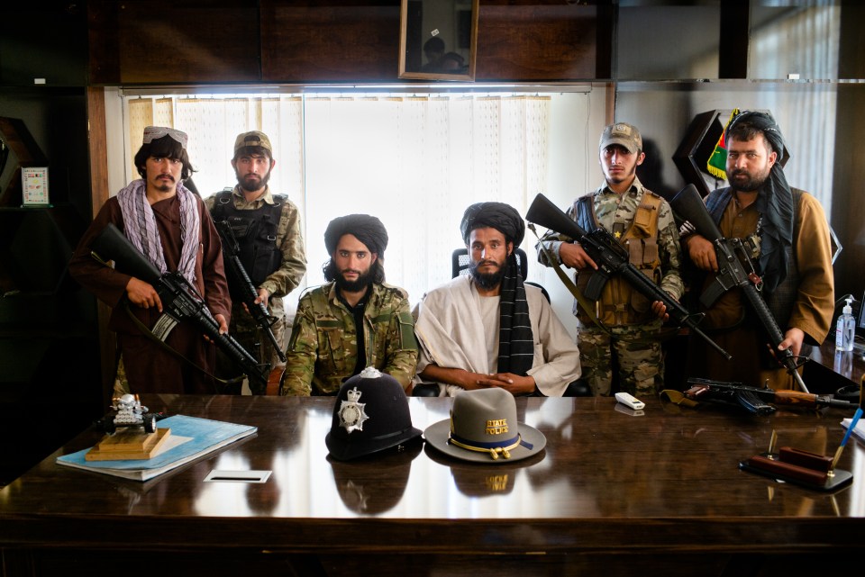 Taliban zealots pose with their weapons in the former British police training HQ in Kabul