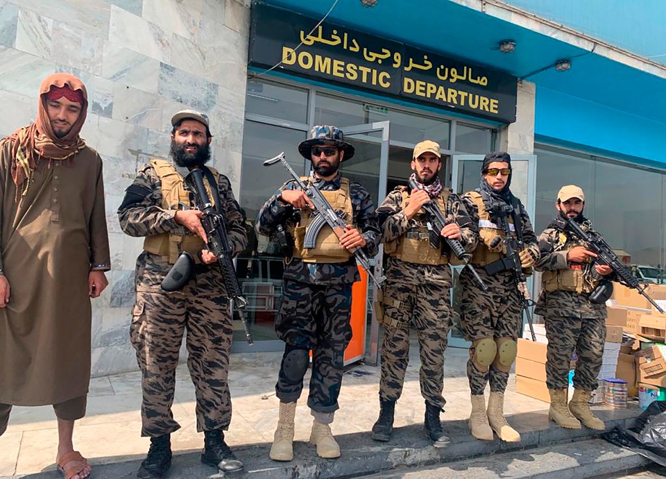 Taliban fighters stand guard outside the Hamid Karzai International Airport today