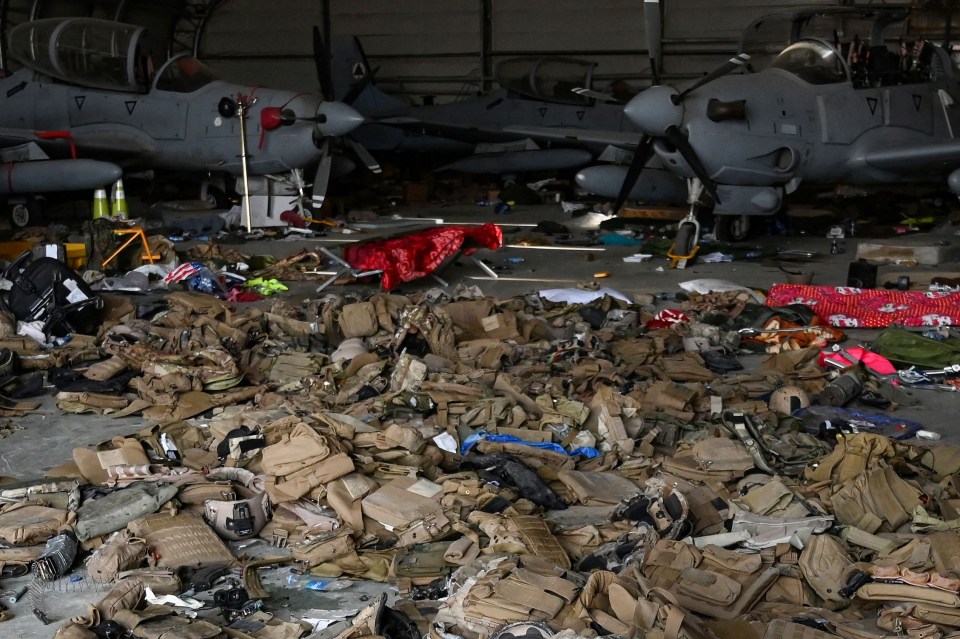 Disgarded military kit ias left strewn across an aircraft hangar at Kabul Airport