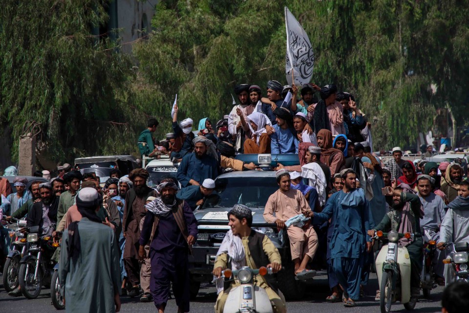 Taliban fighters rally to celebrate the withdrawal of US forces in Kandahar