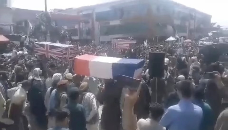 Fake coffins draped with the British, American, French and NATO flags were today paraded through the streets