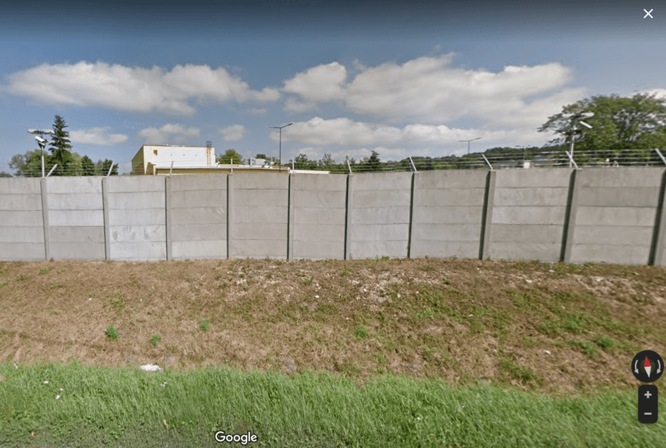 A Street View image from the road nearby just shows concrete walls along the secret area