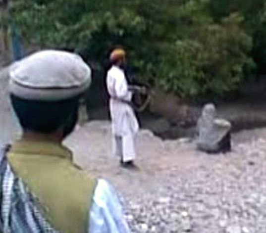 A woman is shot by a Taliban fighter