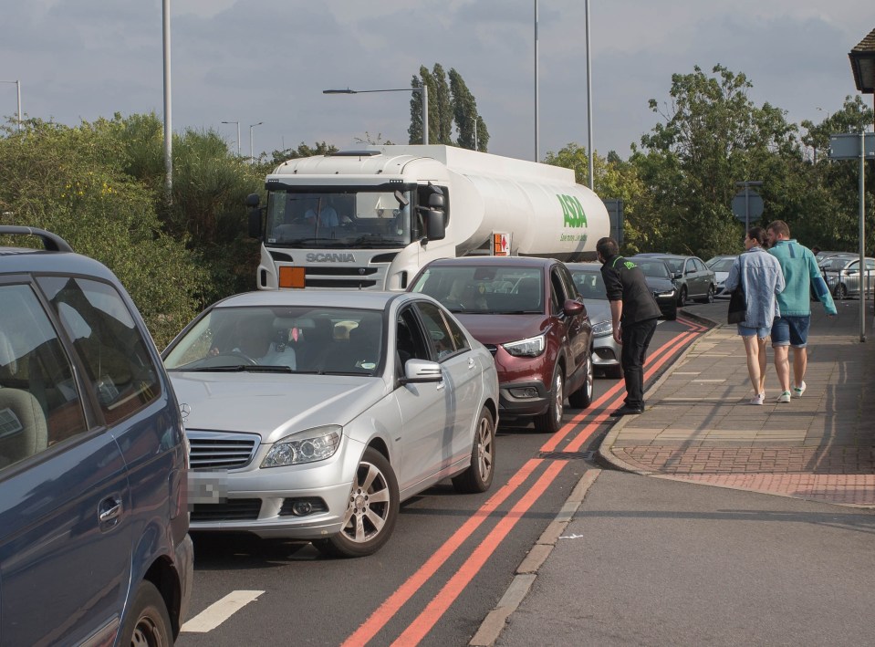 A lorry delivering fuel was blocked by the queue in West London