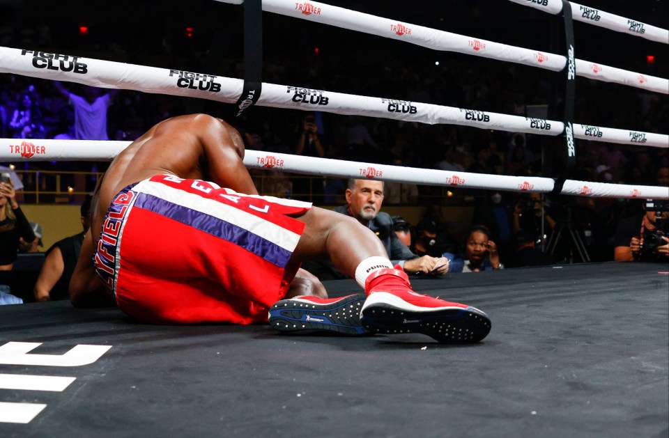 Evander Holyfield lays on the mat after being knocked down by Vitor Belfort