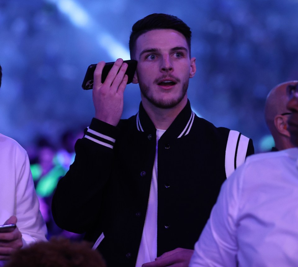 Declan Rice takes a phone call in the stands