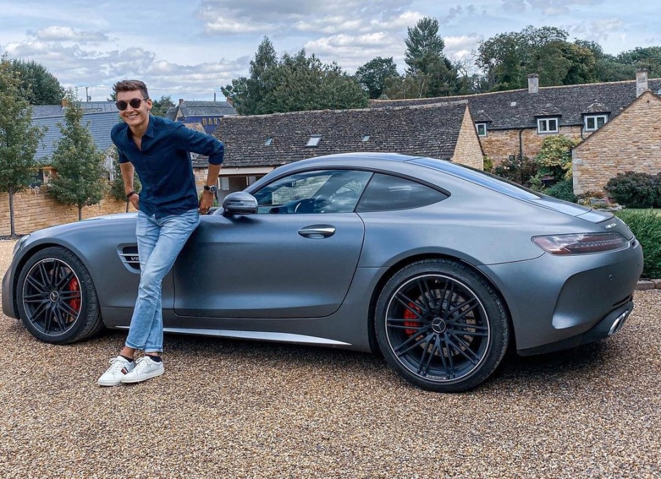 Russell shows off his prized possession - a £140,000 Mercedes AMG GT