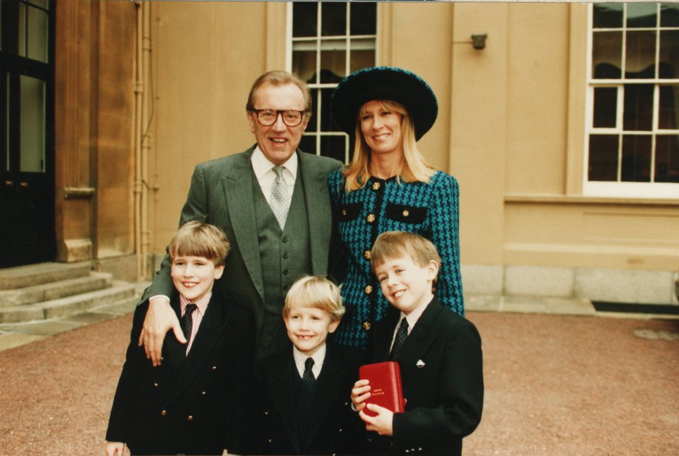 Sir David with wife Carina and their three sons at Buckingham Palace