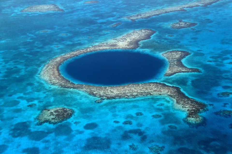 The Great Blue Hole off the coast of Belize is more than 400ft deep