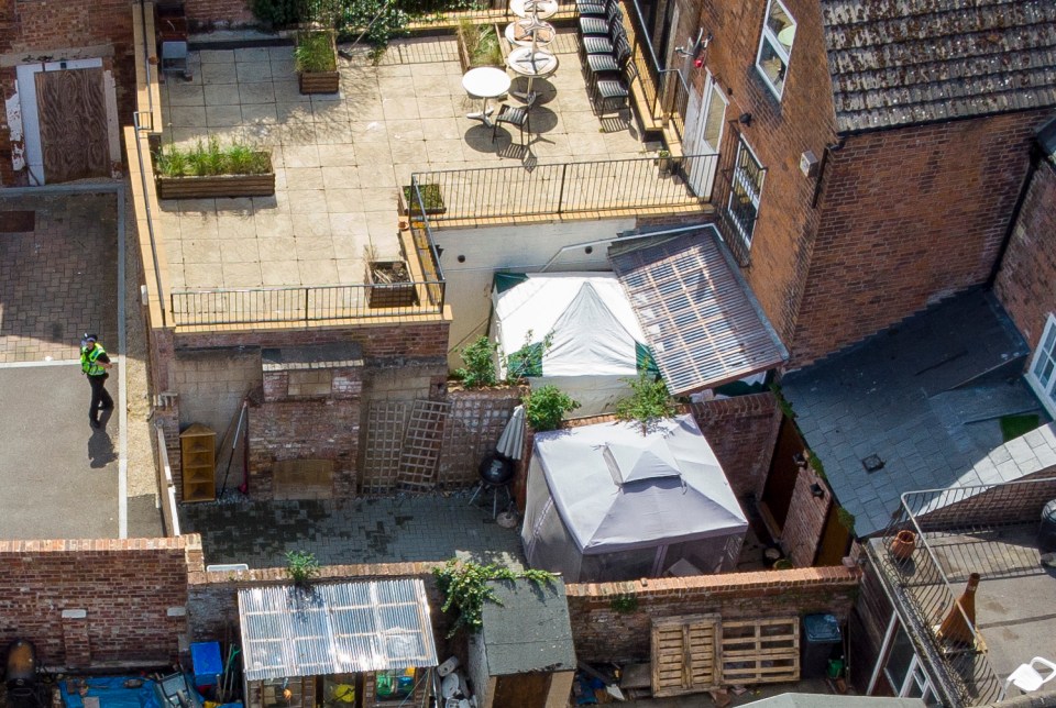 A police tent in the rear of the Clean Plate cafe near Gloucester Docks