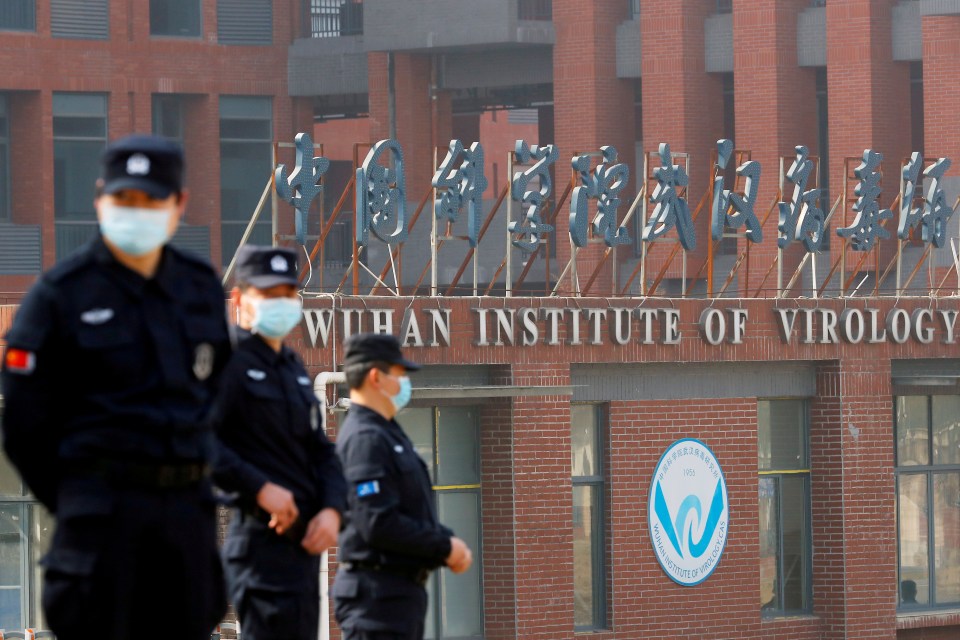 Security personnel keep watch outside the Wuhan Institute of Virology which Donald Trump believes Covid-19 leaked from