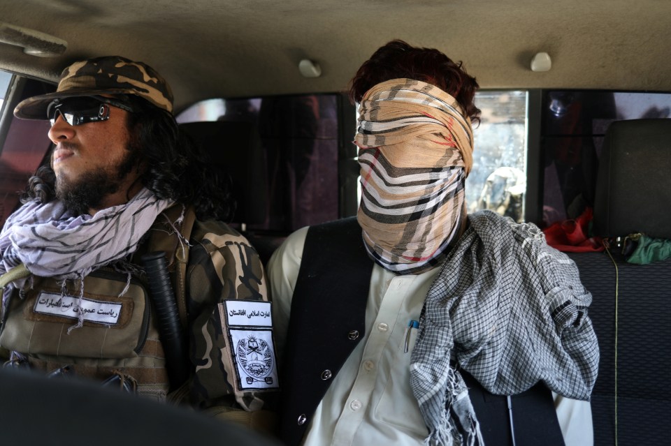 A suspected ISIS member sits blindfolded in a Taliban Special Forces’ car in Kabul