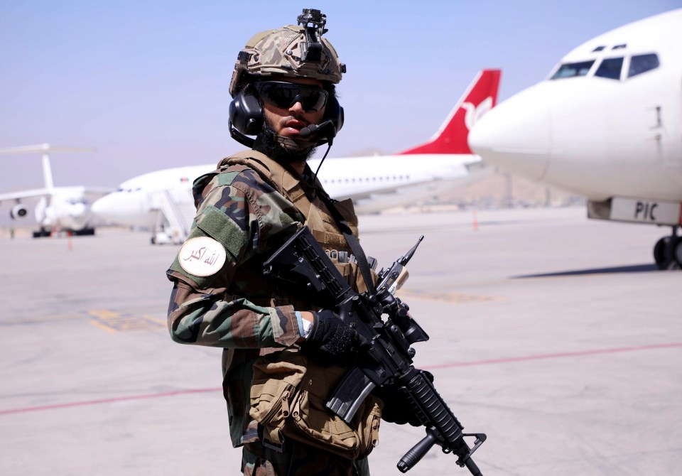 A member of Taliban forces stands guard at Hamid Karzai International Airport in Kabul