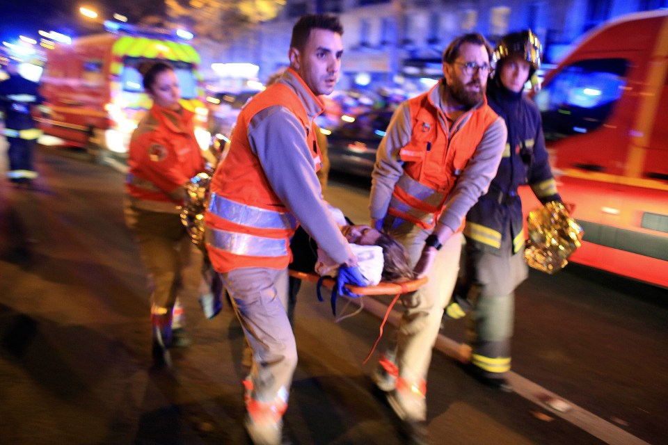 A person injured at the Bataclan concert venue being stretched away