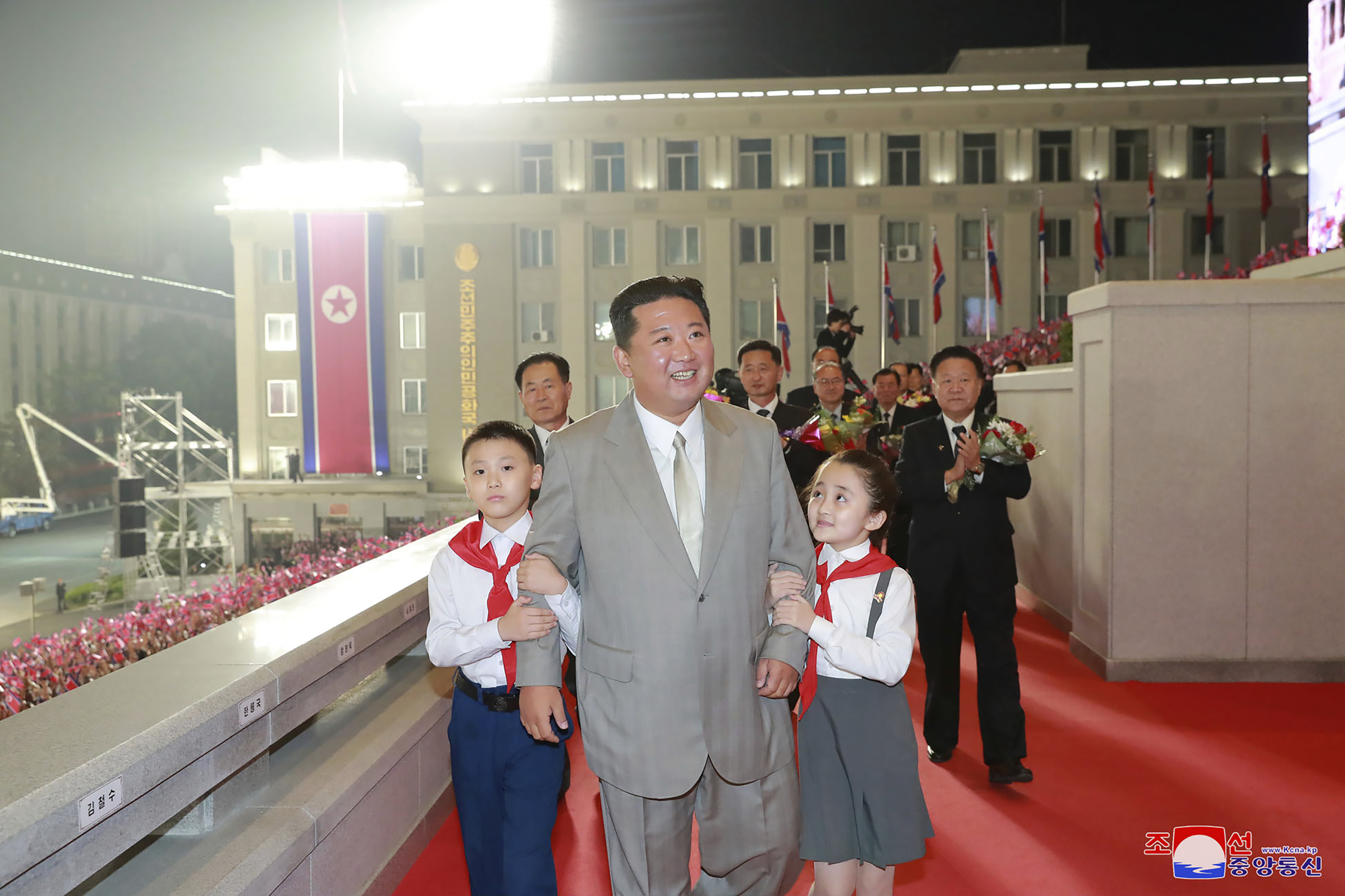 Kim Kong-un was pictured being hugged by adoring children during the parade