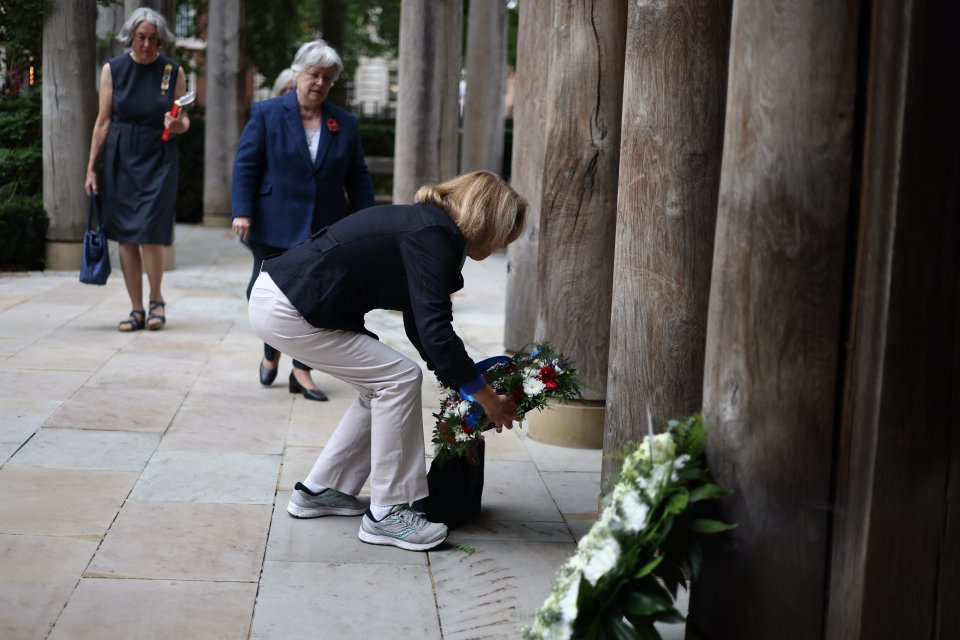 Flowers are laid at the 9/11 memorial in London