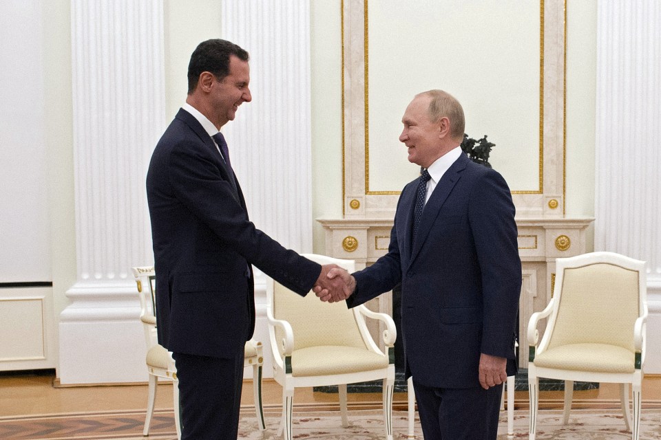 Putin shook hands during a meeting with Syria’s Bashar al-Assad yesterday