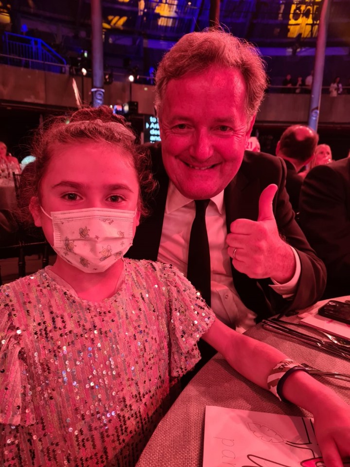 New Sun columnist Piers Morgan gives a thumbs-up as he poses with brave Carmela