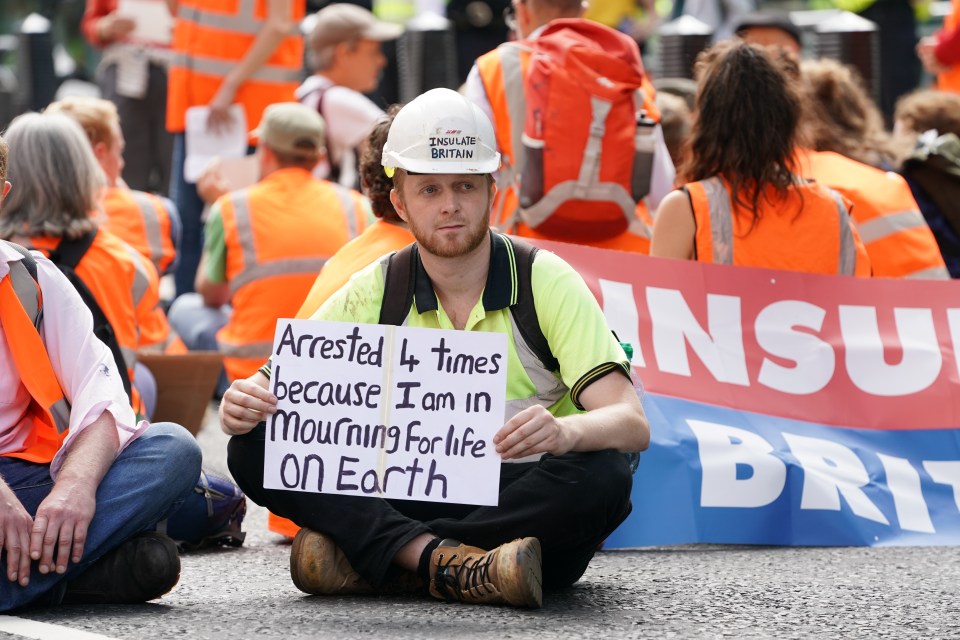 Smith led a march on the Home Office carrying a placard reading 'Arrested 4 times because I am mourning for life on Earth'