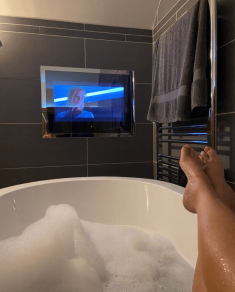 Kerry's bathroom features a TV above the bath