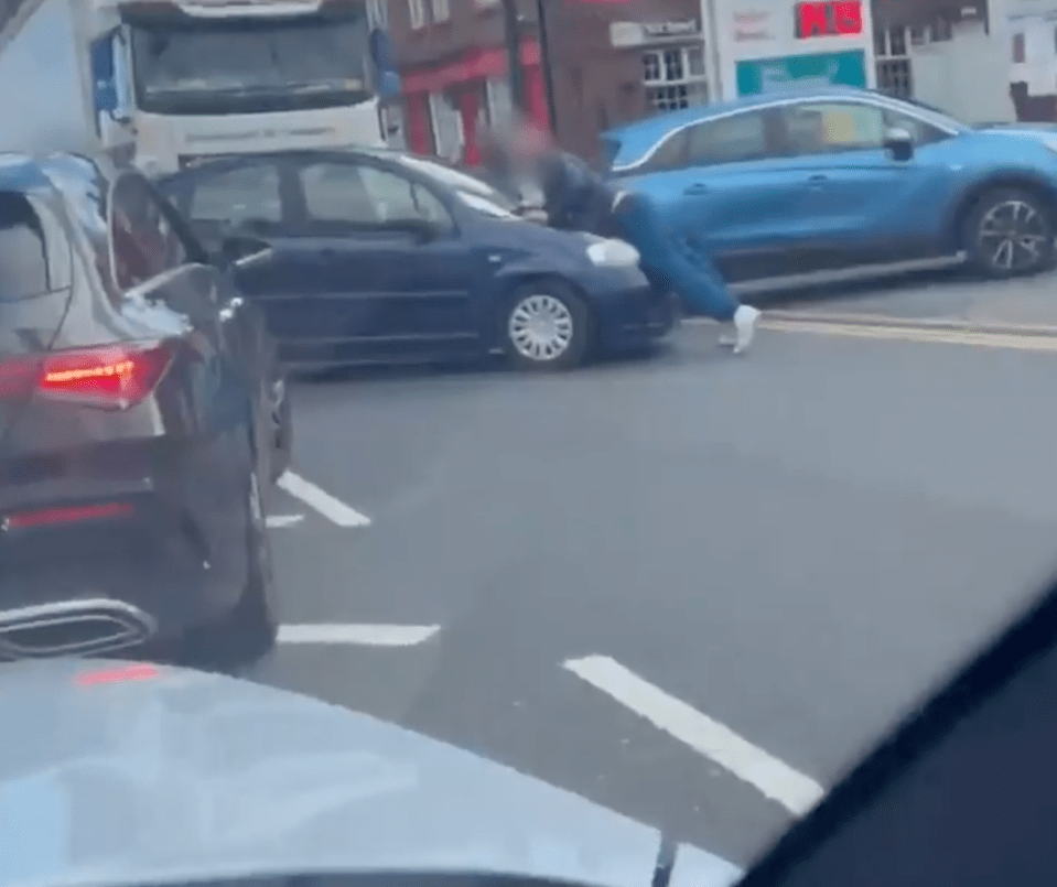 The motorist then DRIVES into the man – pushing him onto his bonnet