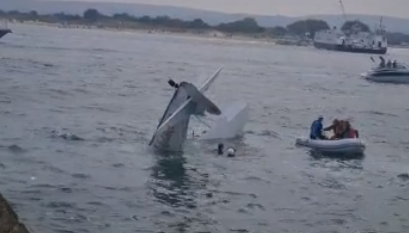 The wingwalker and pilot were heard screaming for help in the water