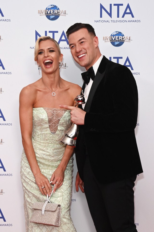 a man and a woman are posing for a picture at the nta national television awards