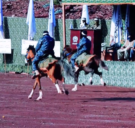 Taliban fighters rode horses as they showed off in front of their leaders