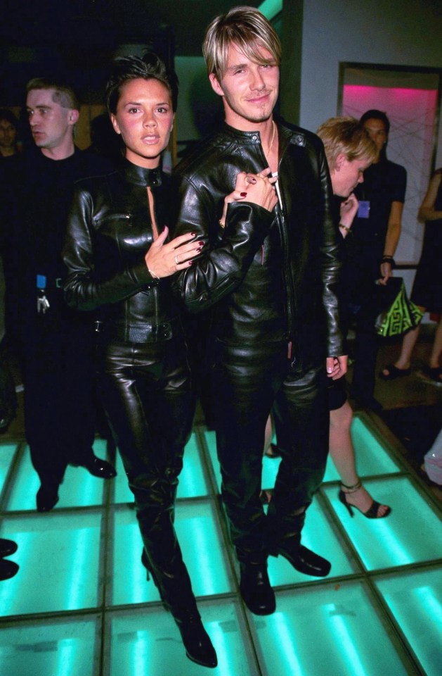 Victoria and David wearing  matching Gucci leather suits at 1999 Versace party