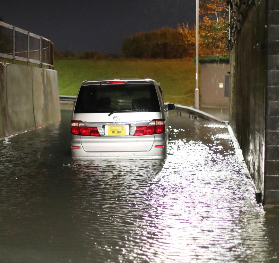 A car seen tyre-deep in the floodwater in Southend, Essex