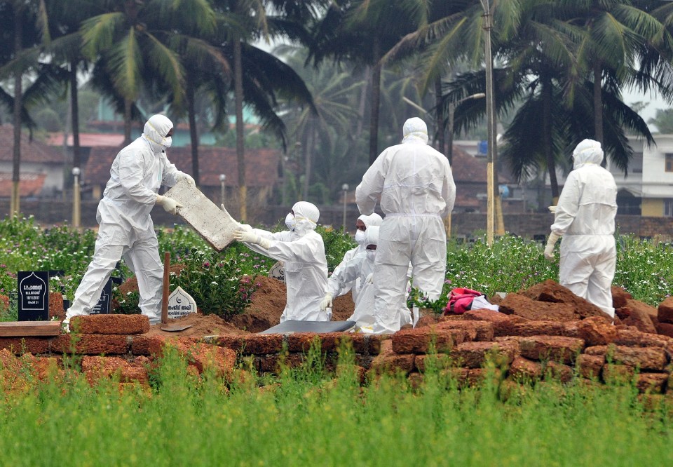 Health workers at the burial of a Nipah virus victim in Kerela, India, 2018