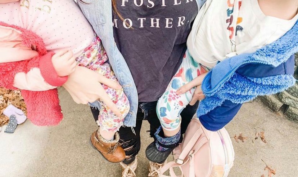 Lauren carrying her two foster daughters