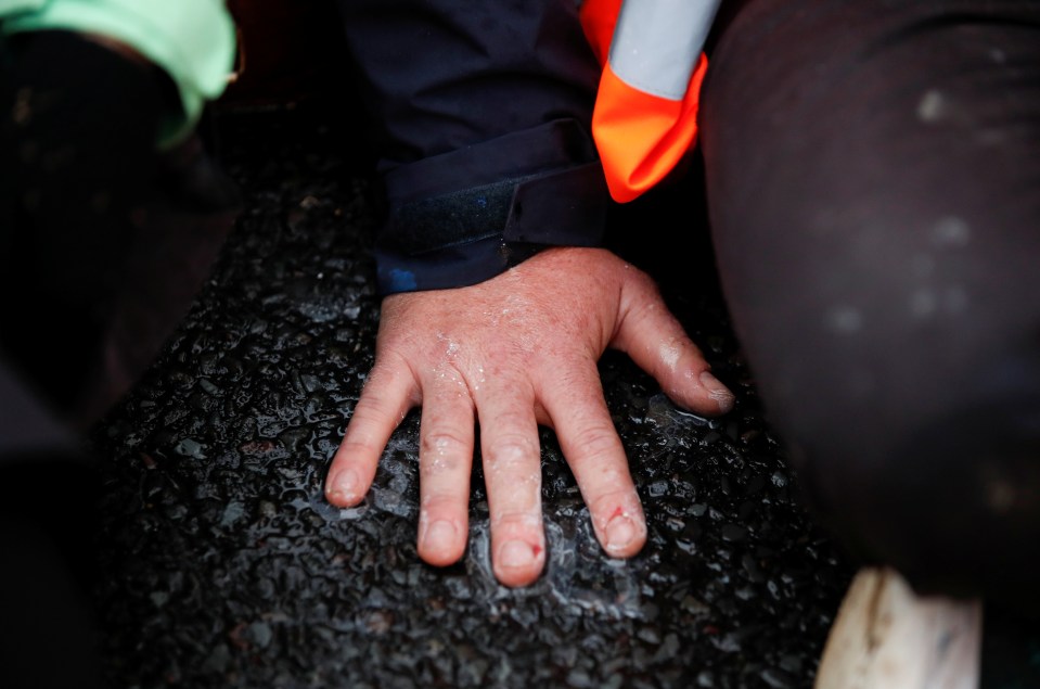 One activist glued to the road surface