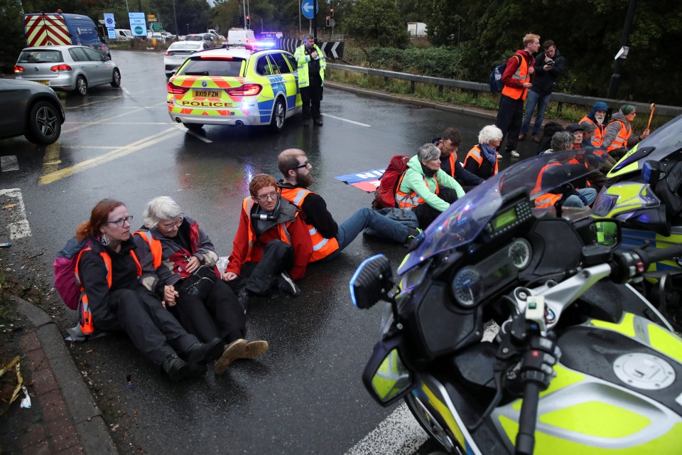 Demonstrators tie themselves together as they block the motorway